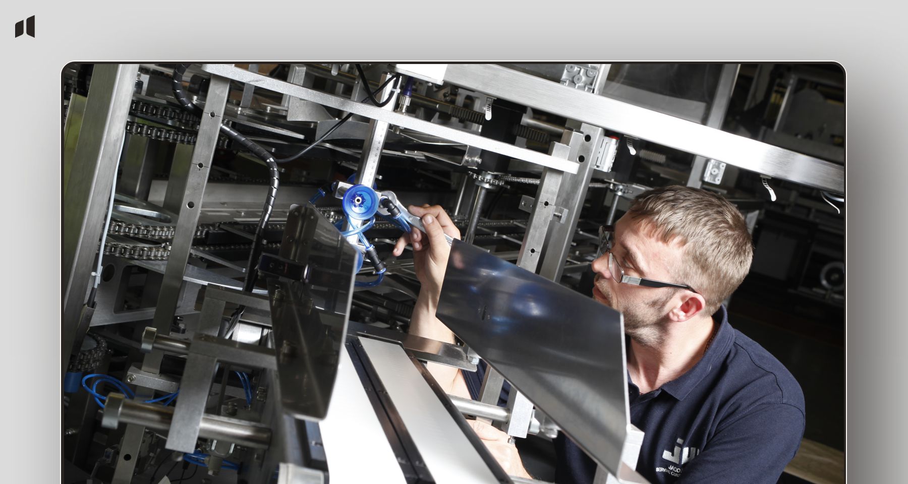 Engineer working on packaging machinery at Jacob White, part of SEO case study by Averma in Surrey.