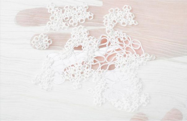 digicrafted 3d printed mesh textile sample hand holding soft mesh-like 3d-printed textile sample from digicrafted project