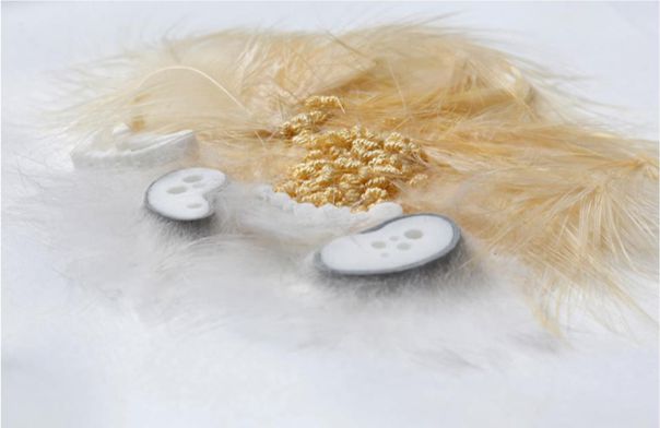 digicrafted textile detail with feathers and 3d components close-up of digicrafted textile piece with feathers, beads and 3d-printed elements